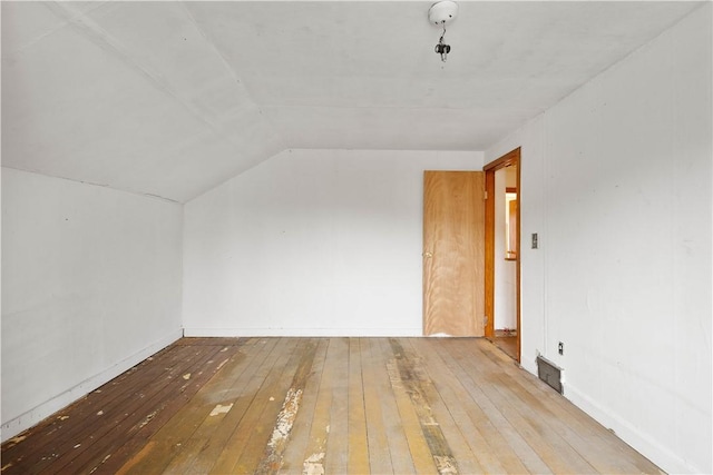 bonus room with lofted ceiling and hardwood / wood-style flooring