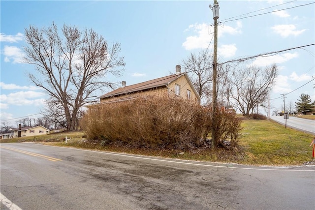 view of side of home with a chimney