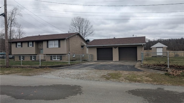 view of front of property featuring brick siding, a fenced front yard, and an outdoor structure