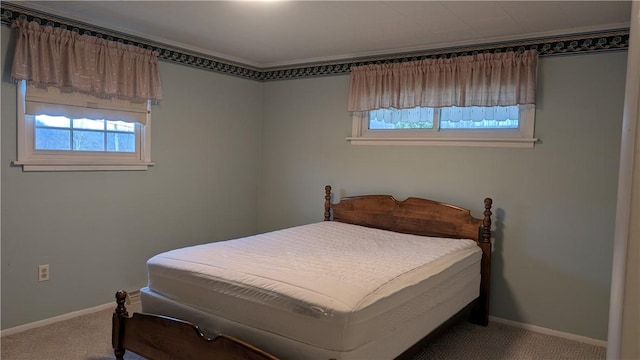 carpeted bedroom featuring baseboards