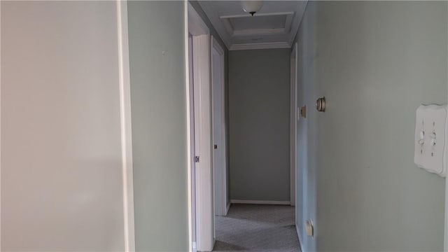 corridor featuring carpet, attic access, and baseboards