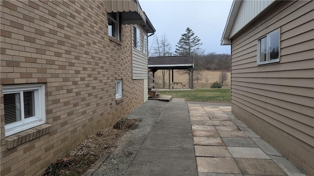 view of side of property featuring brick siding