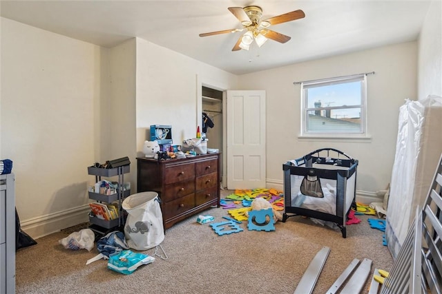 playroom featuring carpet, baseboards, and ceiling fan