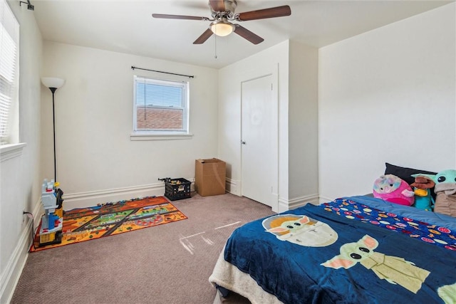 carpeted bedroom featuring a ceiling fan and baseboards