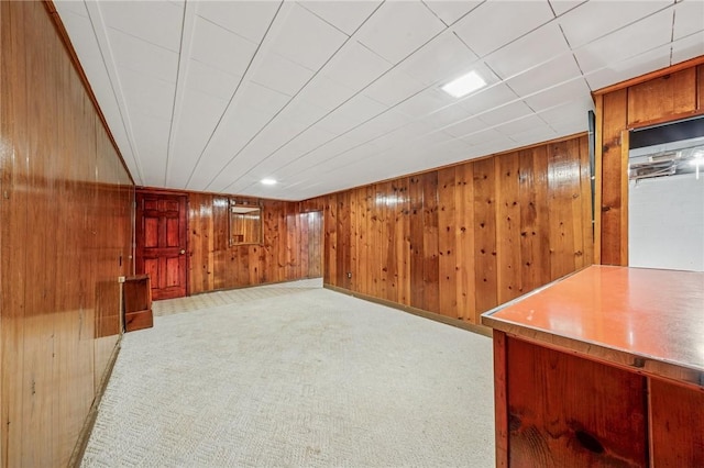 finished basement with carpet floors and wooden walls