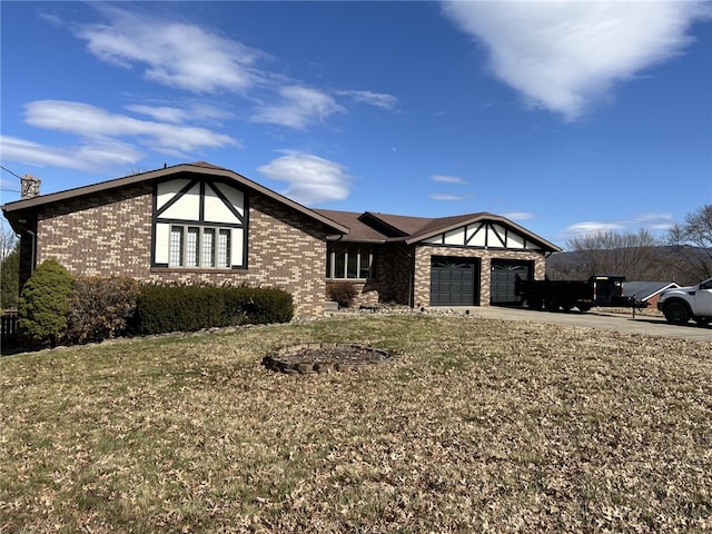 view of front facade with a garage, driveway, brick siding, a chimney, and a front yard