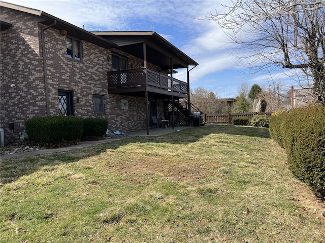 view of yard with a patio area, fence, and stairs