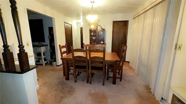 dining area with light carpet and a notable chandelier