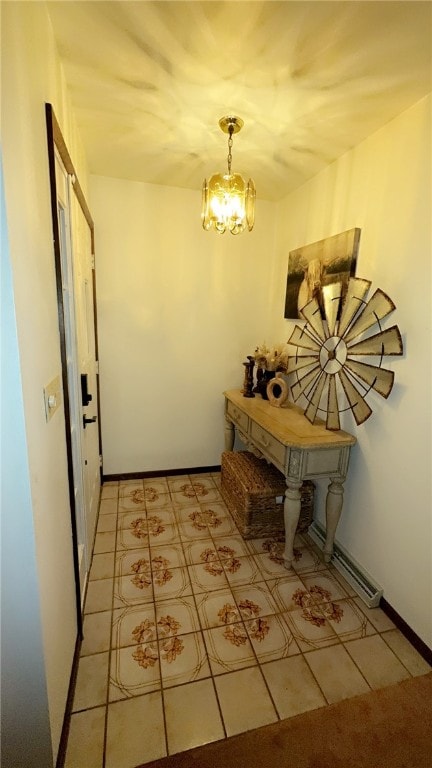 doorway featuring baseboards and a notable chandelier