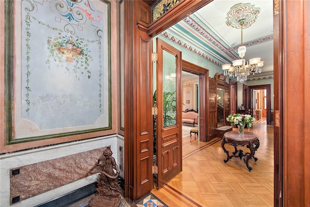 hallway with ornamental molding and a notable chandelier