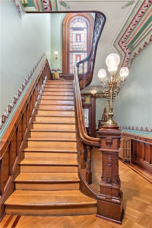 stairway featuring a wainscoted wall