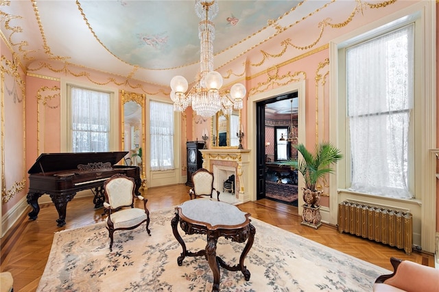 sitting room with wallpapered walls, radiator heating unit, a fireplace, and baseboards