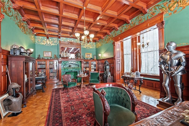 living area featuring wooden ceiling, coffered ceiling, a fireplace, and an inviting chandelier