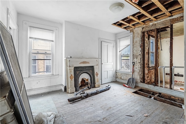 living area featuring a fireplace with raised hearth