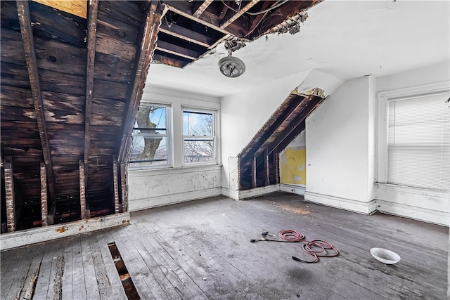 bonus room with hardwood / wood-style flooring and baseboards