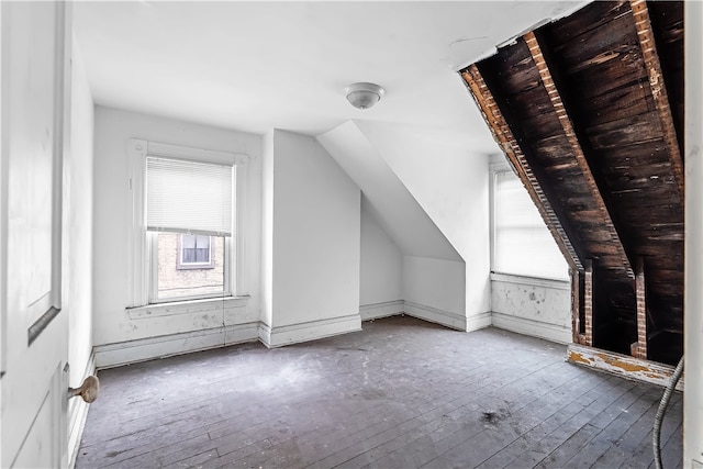 additional living space with lofted ceiling, baseboards, and hardwood / wood-style floors