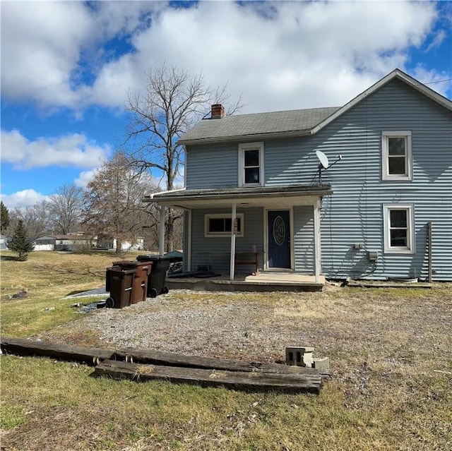 view of front of house featuring covered porch and a chimney