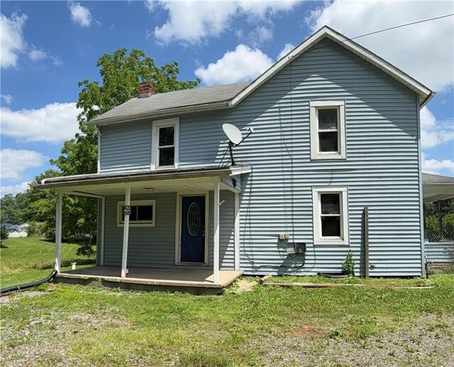 2343 Downing Ln, Hermitage, PA 16148 - view of front of house featuring covered porch, a chimney, and a front lawn