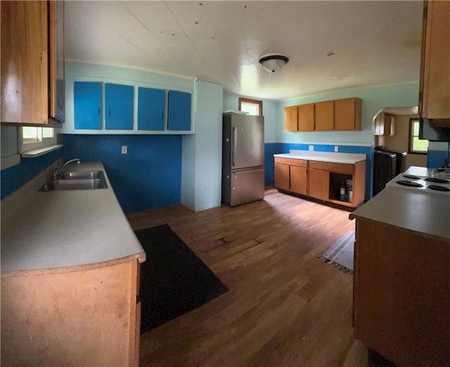 2343 Downing Ln, Hermitage, PA 16148 - kitchen featuring freestanding refrigerator, wood finished floors, brown cabinets, light countertops, and stovetop