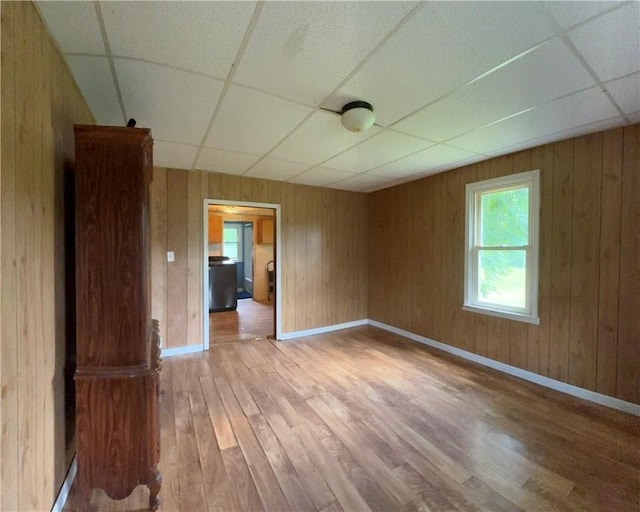 2343 Downing Ln, Hermitage, PA 16148 - unfurnished room featuring a paneled ceiling, light wood-style floors, and wooden walls