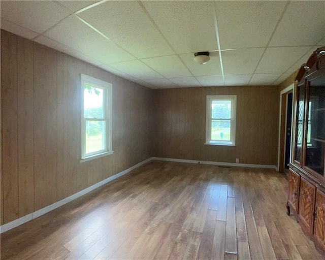 2343 Downing Ln, Hermitage, PA 16148 - empty room with a paneled ceiling, hardwood / wood-style floors, and wooden walls