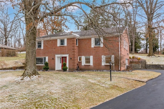 colonial-style house featuring brick siding