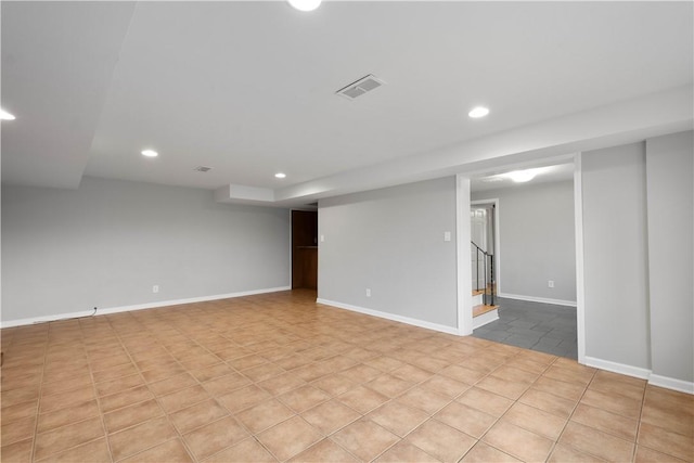 finished below grade area featuring recessed lighting, visible vents, stairway, baseboards, and tile patterned floors