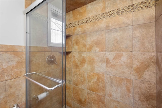 interior details featuring a tile shower