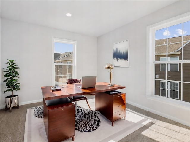 carpeted office space with a wealth of natural light, baseboards, and recessed lighting