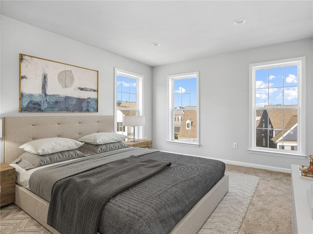 bedroom featuring carpet floors, recessed lighting, multiple windows, and baseboards