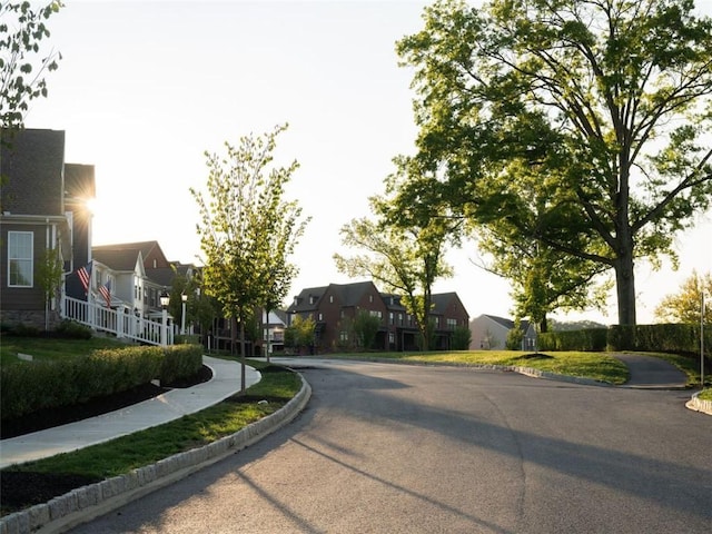 view of street featuring sidewalks, a residential view, and curbs