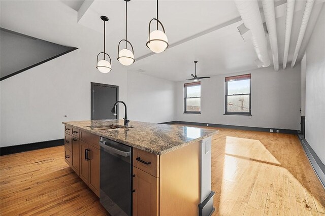 kitchen featuring light wood finished floors, ceiling fan, stainless steel dishwasher, and a sink