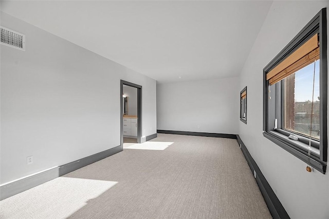 unfurnished room featuring light carpet, baseboards, and visible vents