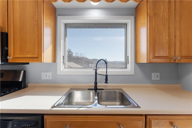 kitchen with brown cabinetry, light countertops, a sink, and dishwasher