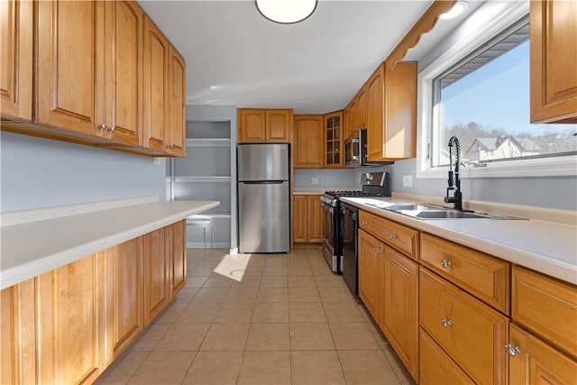 kitchen with light tile patterned floors, light countertops, appliances with stainless steel finishes, glass insert cabinets, and a sink