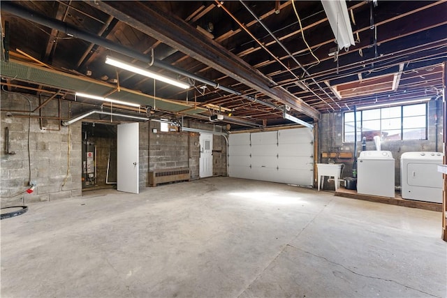 garage with gas water heater and washer and dryer