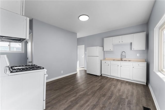 kitchen with white appliances, baseboards, white cabinets, light countertops, and a sink