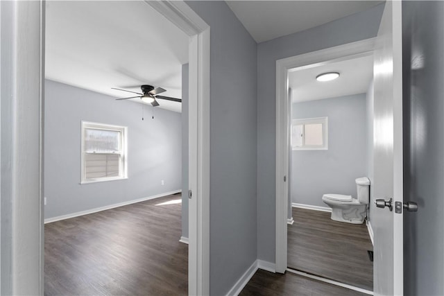 bathroom with a ceiling fan, baseboards, toilet, and wood finished floors