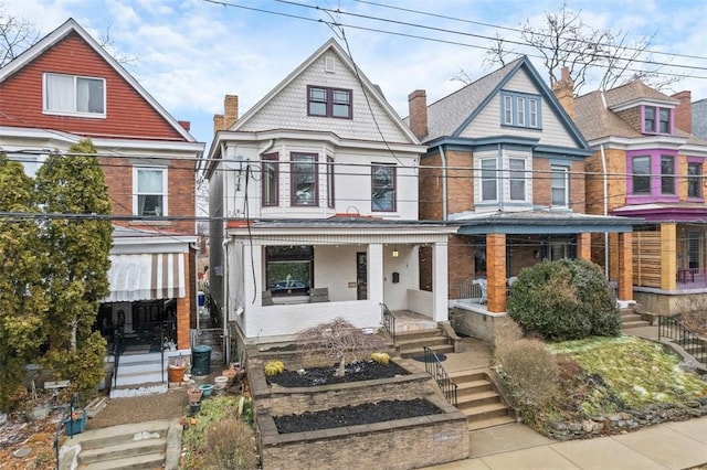 victorian-style house with a balcony and covered porch