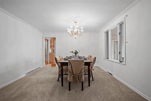 carpeted dining room with baseboards, visible vents, ornamental molding, a baseboard heating unit, and a notable chandelier