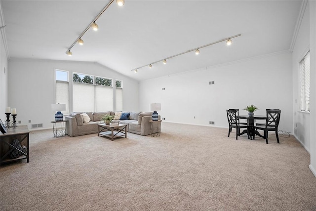 carpeted living room with lofted ceiling, visible vents, crown molding, and rail lighting