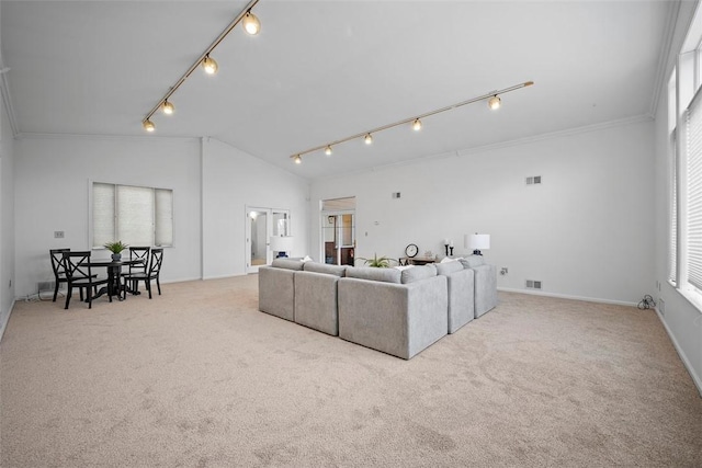 carpeted living room featuring vaulted ceiling, crown molding, visible vents, and track lighting