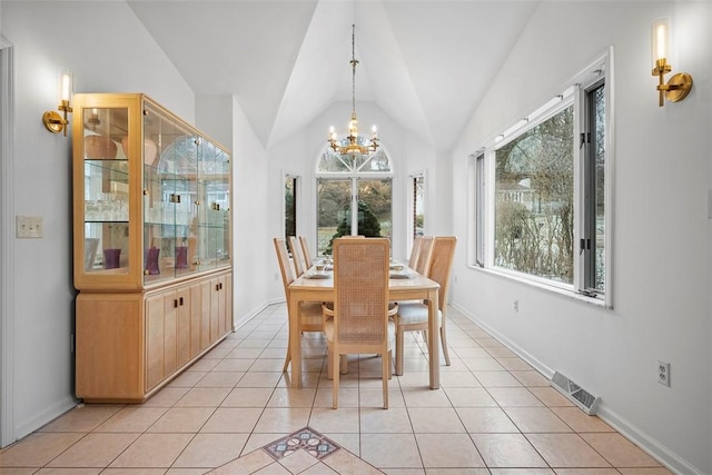 dining space featuring light tile patterned floors, lofted ceiling, visible vents, and an inviting chandelier