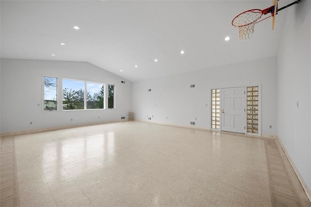 empty room featuring high vaulted ceiling, recessed lighting, baseboards, and light floors