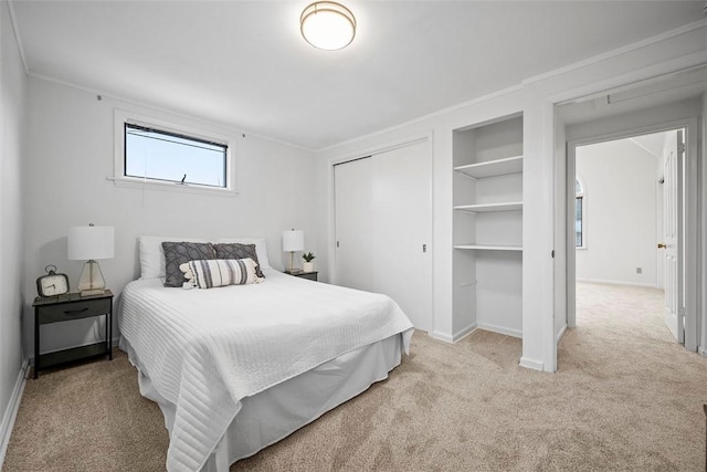 bedroom with ornamental molding, a closet, carpet flooring, and baseboards