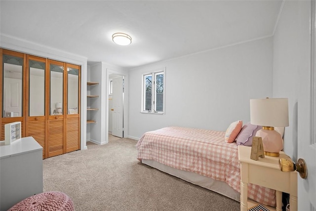 bedroom with carpet floors, baseboards, and crown molding