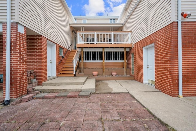 exterior space featuring brick siding and a balcony