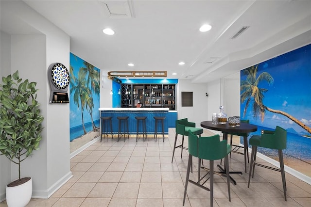 dining room featuring a dry bar, light tile patterned floors, recessed lighting, visible vents, and baseboards