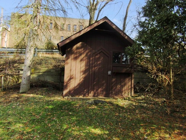 view of shed with fence