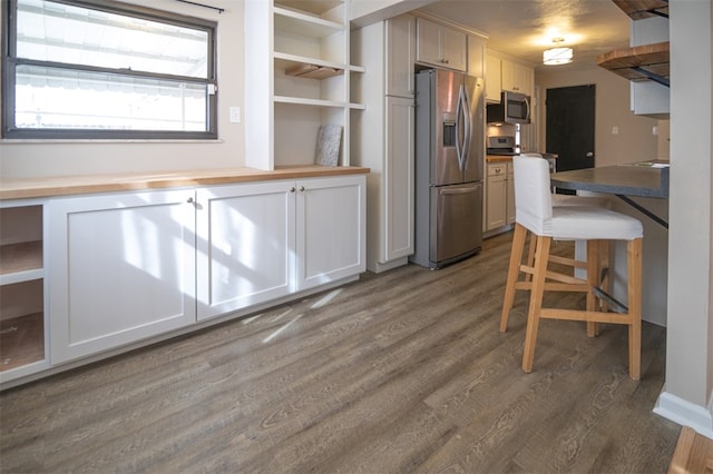 kitchen with open shelves, butcher block counters, stainless steel appliances, and dark wood-style flooring